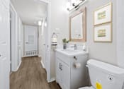 Thumbnail 12 of 79 - a bathroom with a white toilet next to a white sink with a mirror above it  at Sunset Heights, Texas, 78209