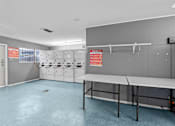 Thumbnail 55 of 79 - a locker room with lockers and a table  at Sunset Heights, San Antonio