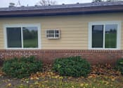 Thumbnail 10 of 15 - a home with two windows and a brick wall