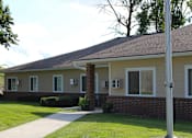 Thumbnail 11 of 18 - Mayer Elderly complex with a grey roof and a grey pole in front of it.