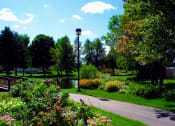 Thumbnail 13 of 54 - a path through a park with flowers and trees