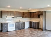 Thumbnail 25 of 54 - a kitchen with dark wood cabinets and white appliances