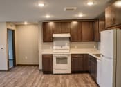 Thumbnail 28 of 54 - a kitchen with dark wood cabinets and white appliances