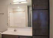 Thumbnail 41 of 54 - a bathroom with a sink and a mirror