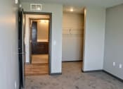 Thumbnail 36 of 54 - a bedroom with a closet and a door that leads to a bathroom