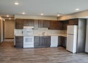 Thumbnail 24 of 54 - a kitchen with white appliances and dark wood cabinets