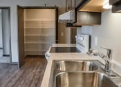 Thumbnail 19 of 54 - a kitchen with a sink and a glasstop stove