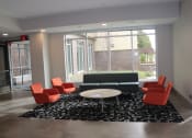 Thumbnail 48 of 54 - a lounge area with a couch and chairs and a coffee table