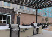 Thumbnail 51 of 54 - three bbq pits in front of a building