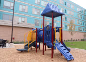 Thumbnail 8 of 54 - a playground at an apartment building with a blue playset