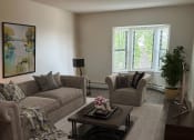 Thumbnail 2 of 13 - a living room with two couches and a coffee table