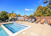 Thumbnail 24 of 29 - A swimming pool surrounded by chairs and trees.