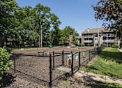 Thumbnail 21 of 23 - A black fence surrounds a playground with a sign on it.