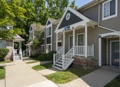 Thumbnail 2 of 27 - a sidewalk in front of two houses with stairs and a porch