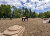 Thumbnail 32 of 36 - a playground with a sandbox and a picnic table in a park