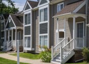 Thumbnail 4 of 27 - a row of suburban homes with stairs and porch