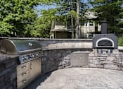 Thumbnail 23 of 23 - A stainless steel outdoor kitchen with a grill and oven.