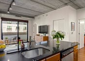 Thumbnail 8 of 29 - Enjoy an open-concept kitchen floorplan featuring sleek quartz countertops and beautiful plank flooring throughout