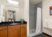 Thumbnail 13 of 29 - Oversized Showers with Subway Tile Surrounds and Spacious Bathroom Vanities