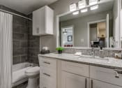 Thumbnail 14 of 16 - a bathroom with a sink and a toilet and a tub