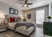 Thumbnail 13 of 16 - a bedroom with a bed and a ceiling fan