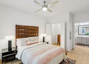 Thumbnail 17 of 140 - Bedroom with geometric headboard and ceiling fan at Matador Apartments, Austin, TX 78745