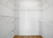 Thumbnail 59 of 116 - Empty white walk in closet with shelves. at Park South Apartments, Austin, TX, 78748