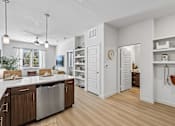 Thumbnail 43 of 127 - A modern kitchen with wooden cabinets and a stainless steel dishwasher.