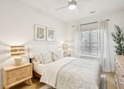 Thumbnail 25 of 140 - Cozy bedroom with natural wood furnishings at Matador Apartments, Austin, Texas