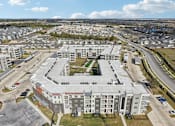 Thumbnail 103 of 103 - Aerial view of apartment community with courtyard at Cantarra Apartments, Manor, 78653
