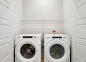 Thumbnail 70 of 116 - Two white washing machines in a laundry room. at Park South Apartments, Austin