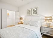 Thumbnail 28 of 140 - Bright bedroom with white bedding and natural wood accents at Matador Apartments, Texas, 78745