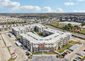 Thumbnail 102 of 103 - Aerial view of apartment community courtyard at Cantarra Apartments, Manor, Texas