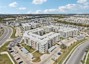 Thumbnail 101 of 103 - Aerial view of modern apartment community at Cantarra Apartments, Manor