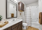 Thumbnail 53 of 127 - A bathroom with a white sink, toilet, and bathtub.