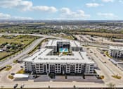 Thumbnail 100 of 103 - Aerial view of apartment community with pool at Cantarra Apartments, Texas