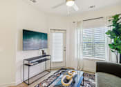 Thumbnail 103 of 140 - Living room with tv console and entry door at Matador Apartments, Austin, 78745