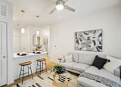 Thumbnail 6 of 140 - Living area with sectional sofa and breakfast bar at Matador Apartments, Austin, Texas