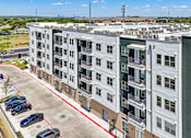 Thumbnail 29 of 127 - A large white building with a red line in the parking lot.