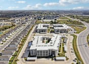 Thumbnail 98 of 103 - Aerial view of residential buildings and townhomes at Cantarra Apartments, Manor, TX 78653