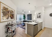 Thumbnail 107 of 140 - Open kitchen and living area with pendant lighting at Matador Apartments, Austin, TX 78745
