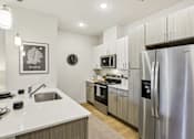 Thumbnail 108 of 140 - Modern kitchen with stainless steel appliances at Matador Apartments, Austin, TX
