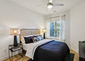 Thumbnail 110 of 140 - Bedroom with upholstered headboard and side table at Matador Apartments, Austin, Texas