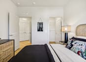 Thumbnail 113 of 140 - Bedroom with cane headboard and modern lamp at Matador Apartments, Texas, 78745