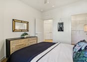 Thumbnail 114 of 140 - Bedroom with woven dresser and walk-in closet at Matador Apartments, Austin, TX