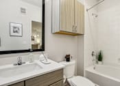 Thumbnail 115 of 140 - Bathroom with overhead cabinet and tiled shower at Matador Apartments, Austin, 78745