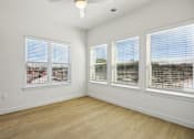 Thumbnail 128 of 140 - Empty bedroom with large corner windows at Matador Apartments, Texas, 78745