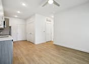 Thumbnail 121 of 140 - Open living area with ceiling fan and hardwood floors at Matador Apartments, Austin, TX