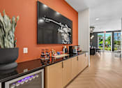Thumbnail 80 of 127 - A modern kitchen with a bar area and a painting of a man holding a gun.