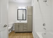 Thumbnail 136 of 140 - Bathroom with tall linen tower and white tile tub at Matador Apartments, Texas, 78745